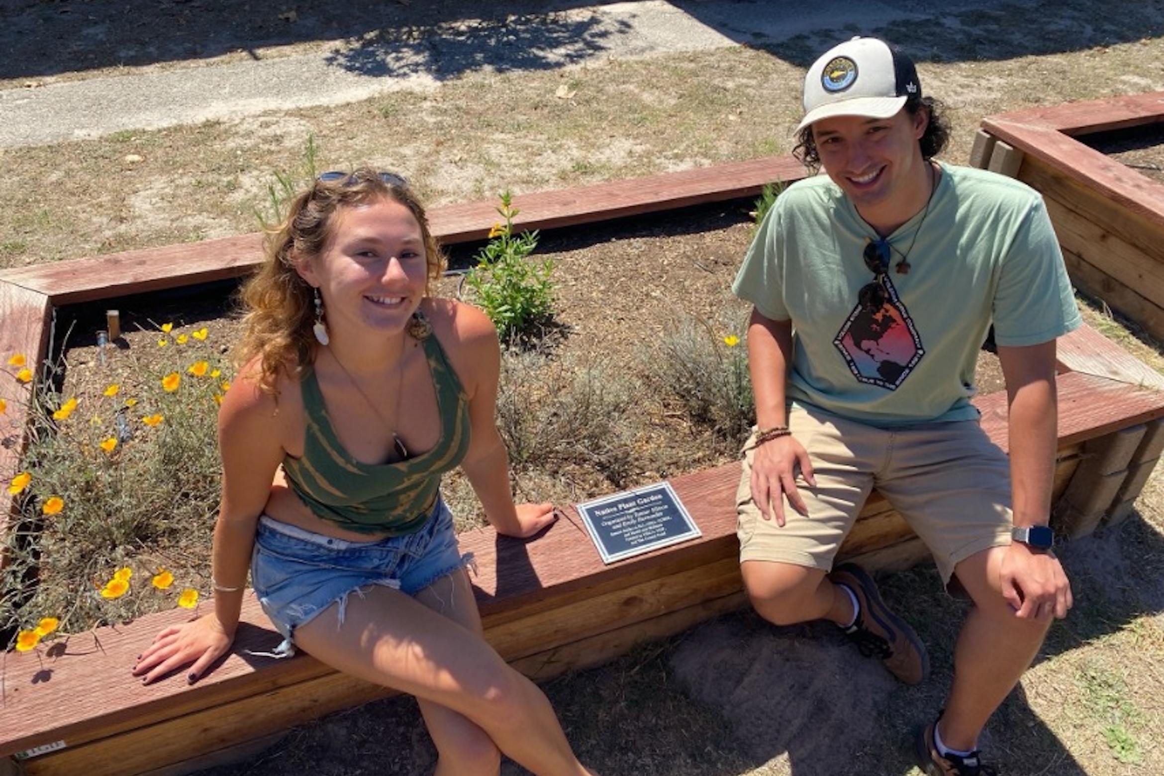 Students, Emily and Tanner, in front of their native garden on the UCSB campus