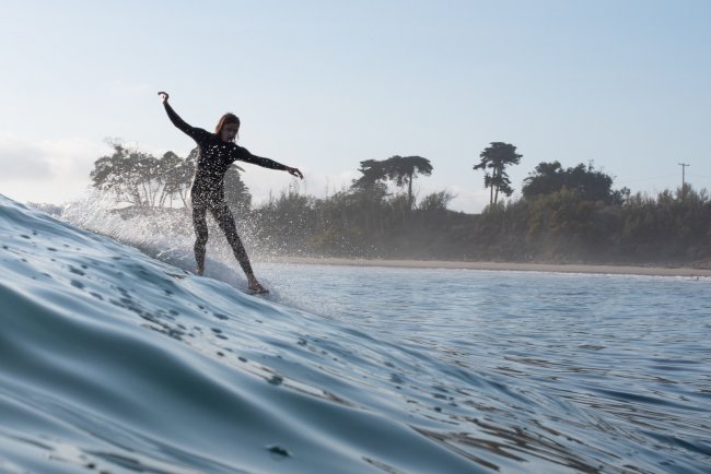 ELI Student Justin Memenas Catching a Wave on a Surfboard