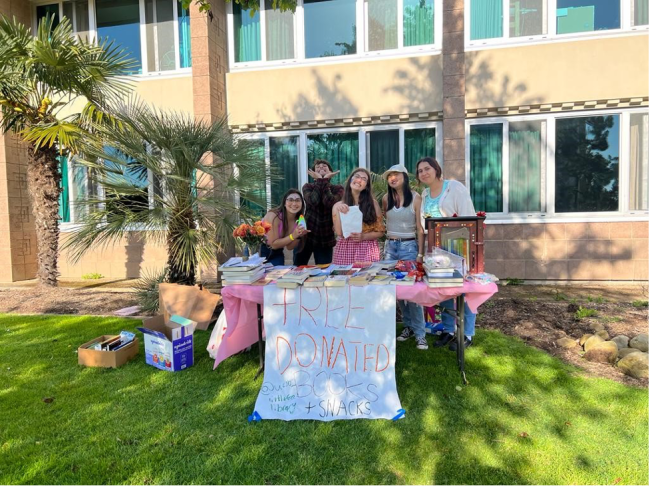 Students handing out free books